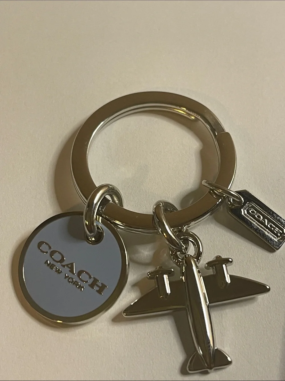 Coach Silver Airplane Keyring with Light Blue Round Charm and Coach Pen